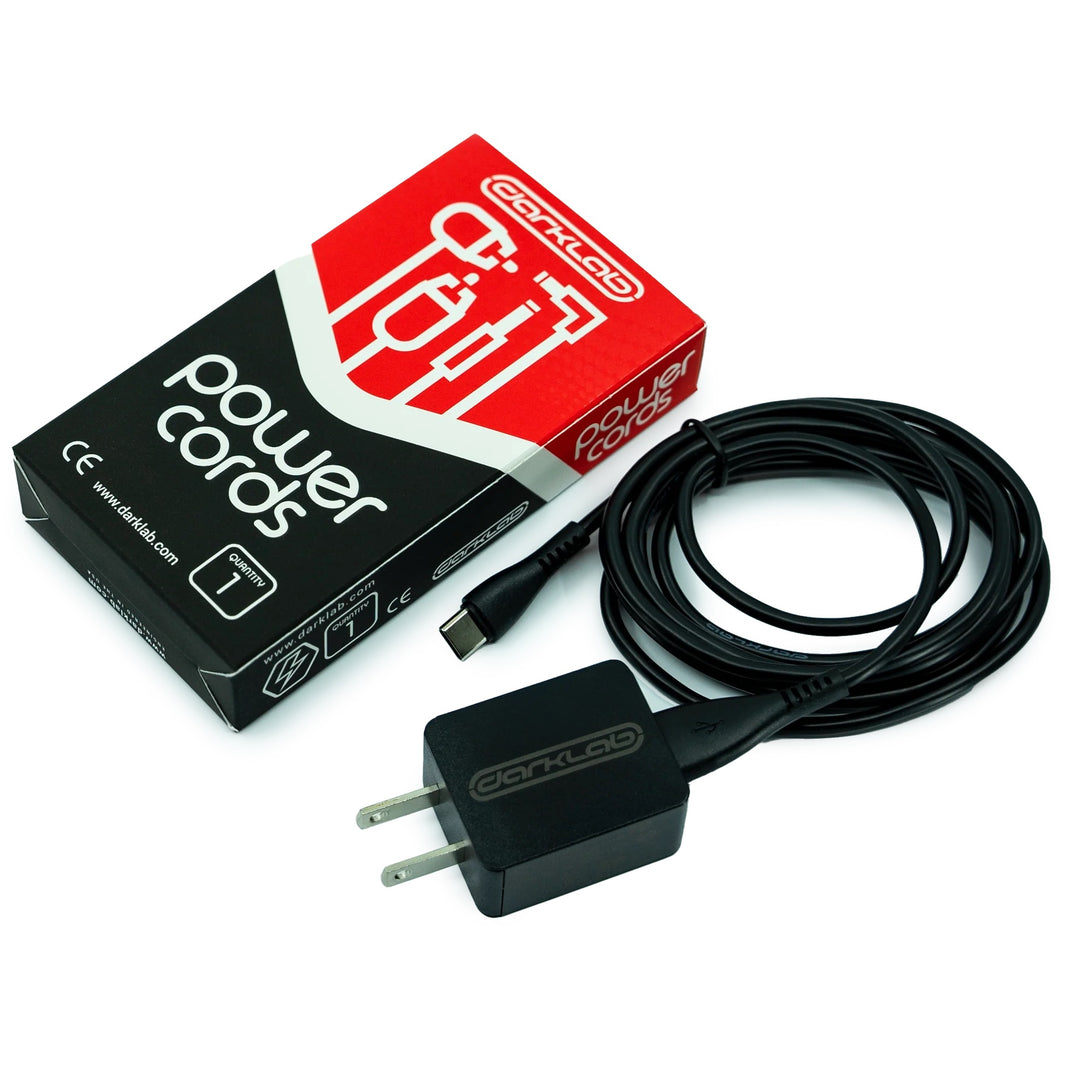 A coiled, black 3-foot USB-C cable with a charging block beside it. This fast-charging accessory enhances device performance and extends battery lifespan. Ideal add-on for device and power pack purchases for sustained mechanical efficiency.