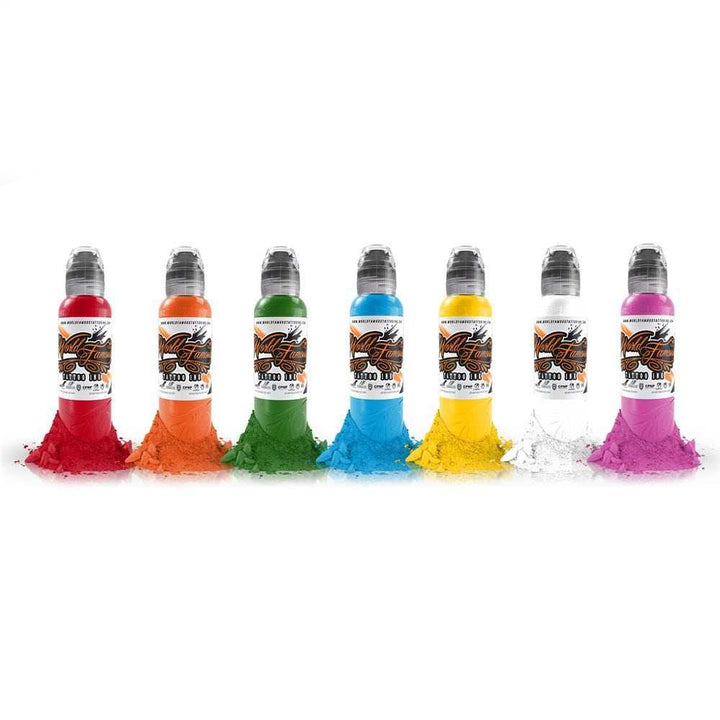 Seven bottles of World Famous Tattoo Ink in a variety of vibrant colors including red, orange, green, blue, yellow, white, and pink, each with matching colored pigment powder at the base of the bottle.